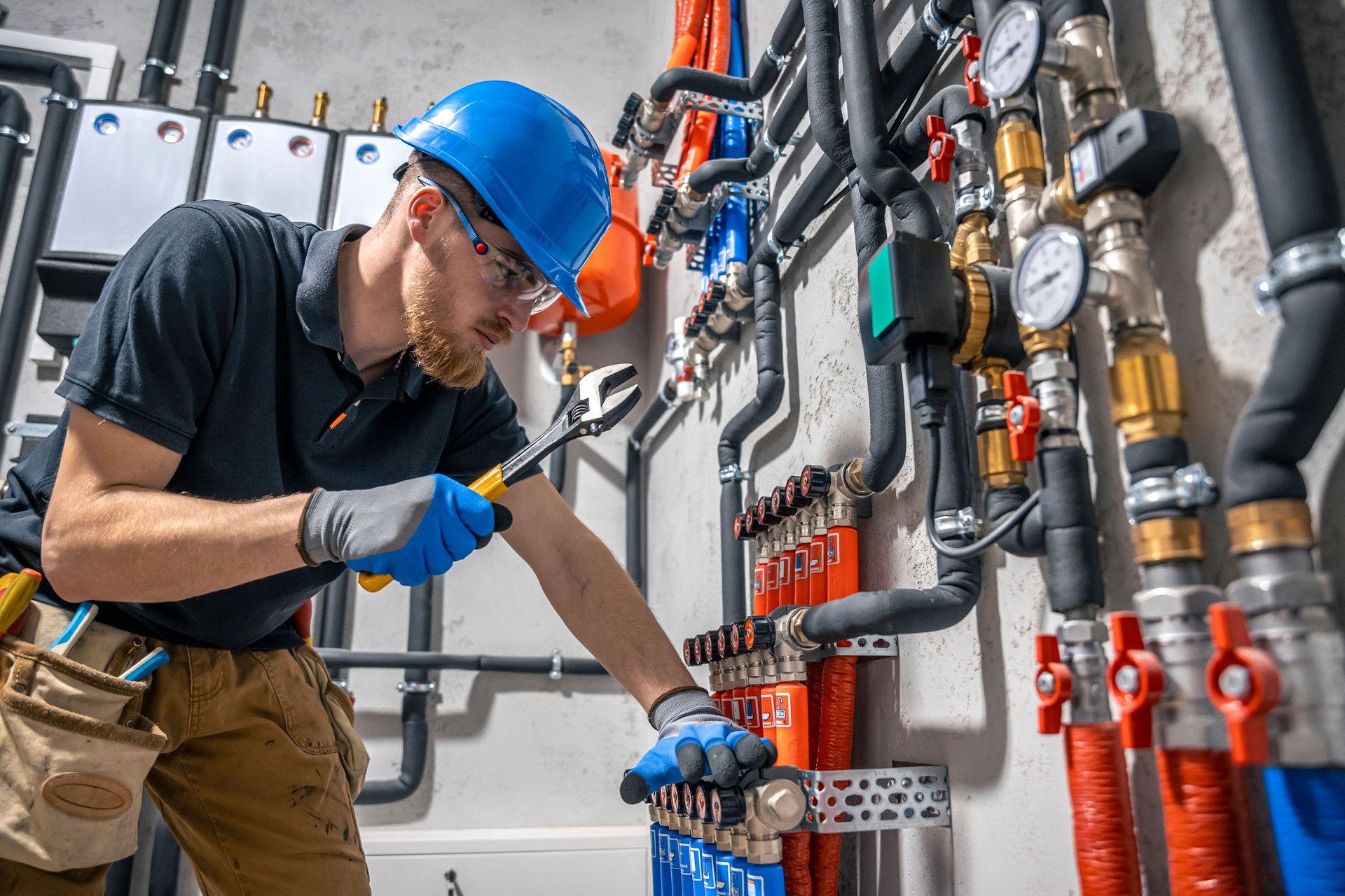 The technician checking the heating system in the boiler room.